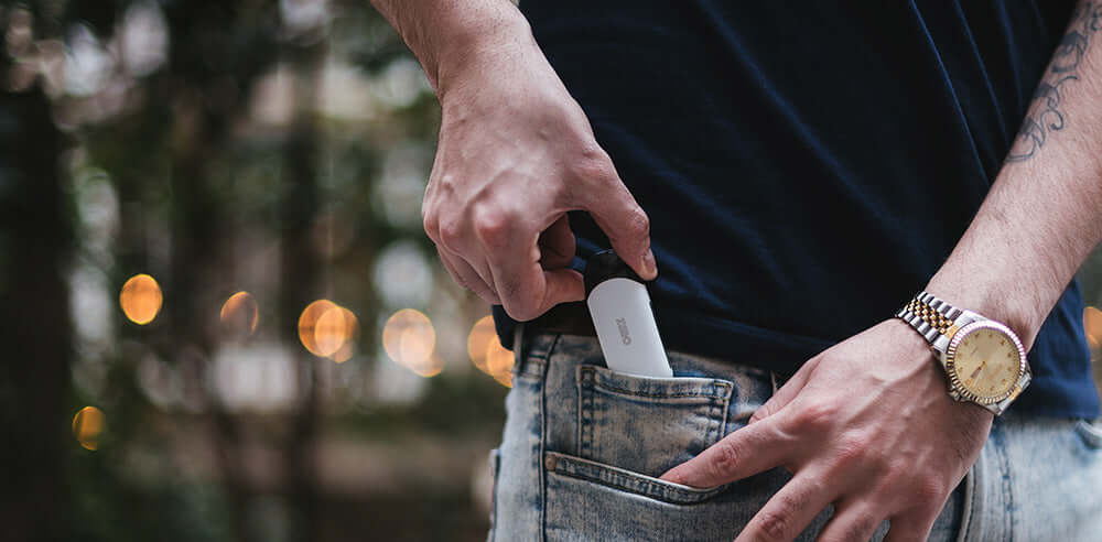 Person placing vape pod in pocket